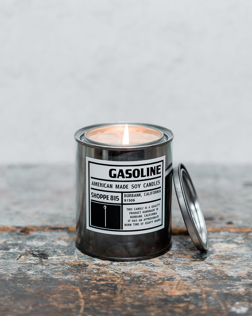 Lit Gasoline gender neutral tin candle on wooden shelf