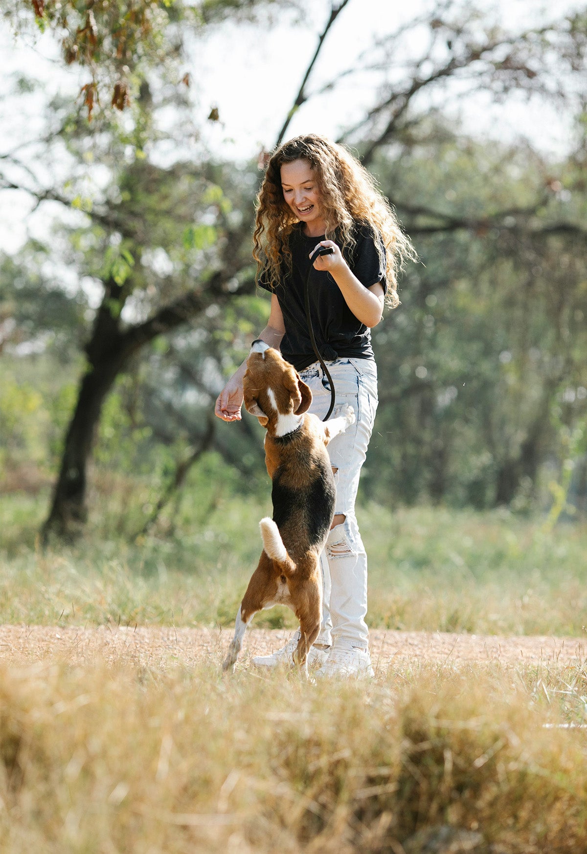 A girl enjoying her daily walk outside with her best four legged friend!  The smell of a simple moment that will ignite memories for years to come! 