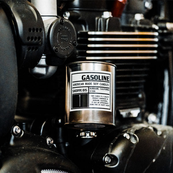 Tin Gasoline candle perched on a Triumph engine.