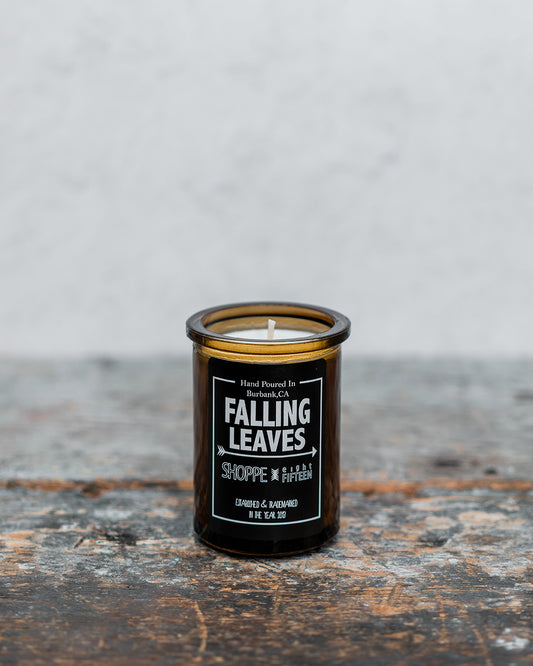 Falling Leaves amber glass candle on wooden shelf