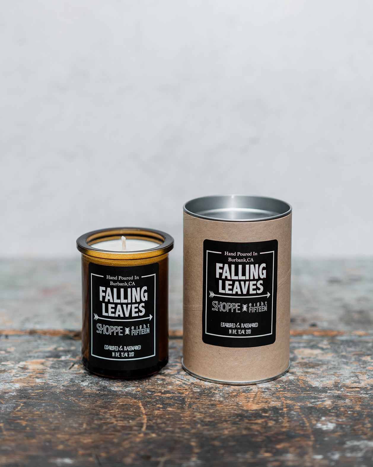 Falling Leaves amber glass candle on wooden shelf with packaging