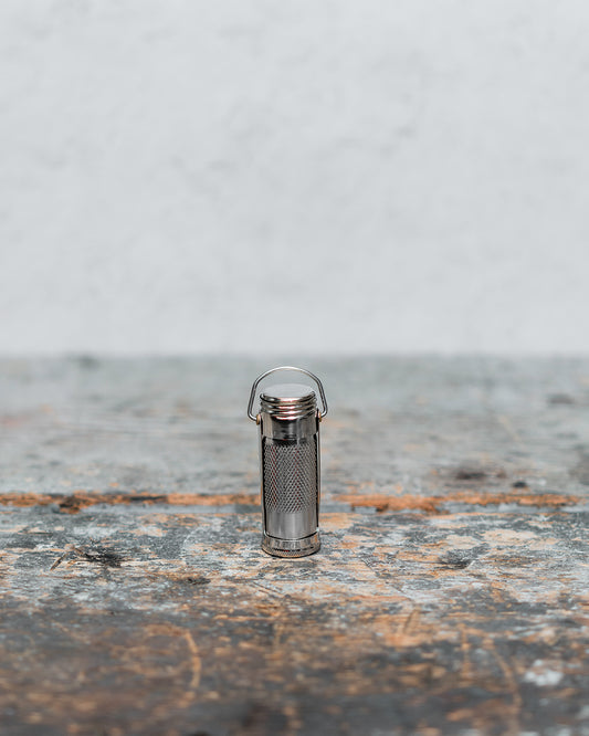 Metal waterproof matchstick case on counter for outdoor enthusiast