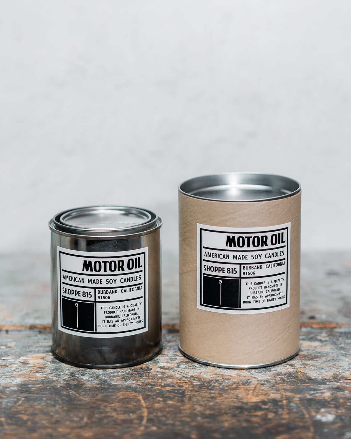 Motor Oil gender neutral tin candle on wooden shelf with packaging