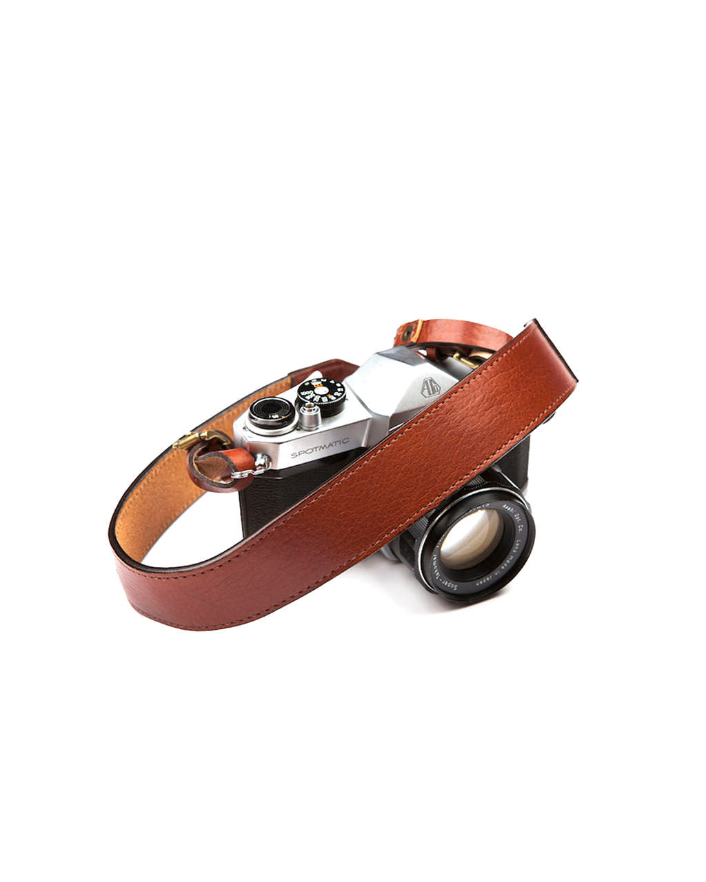 Camera with leather camera strap sitting on table